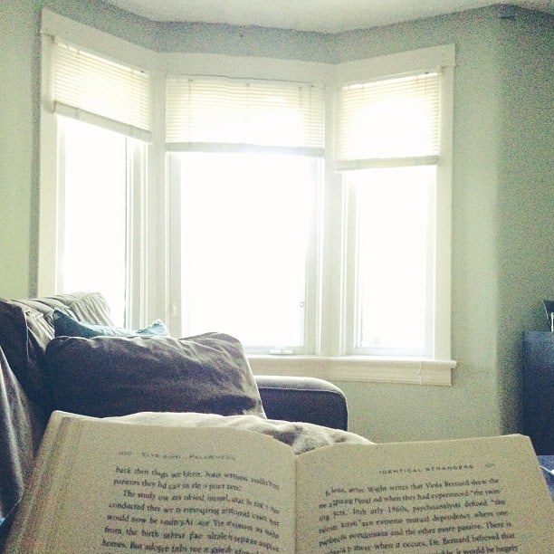 reading on couch by sunlit window