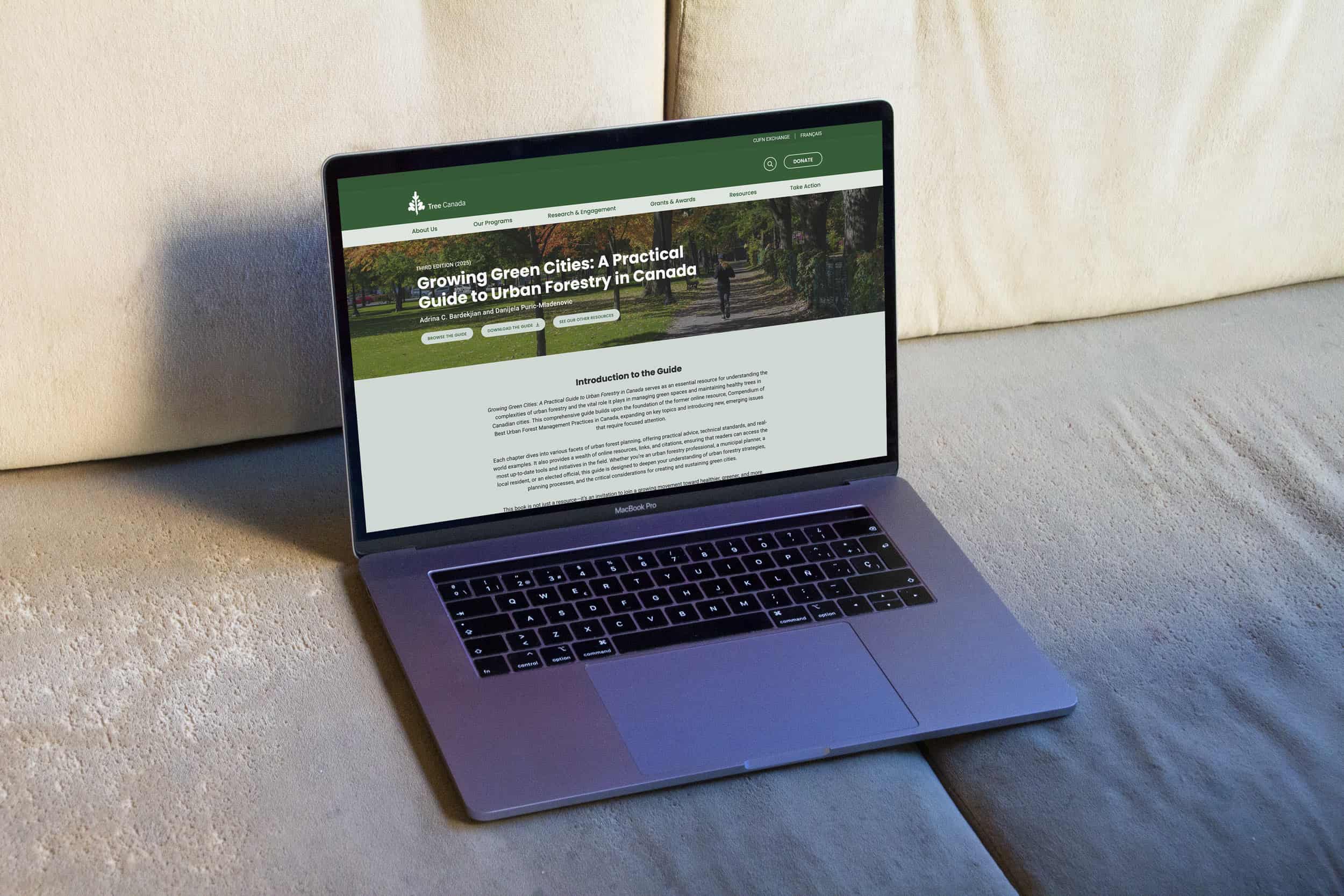 Tree Canada's Urban Forestry Guide resource shown on a Macbook Pro laptop on a couch. The headline reads "Growing Green Cities: A Practical  Guide to Urban Forestry in Canada"