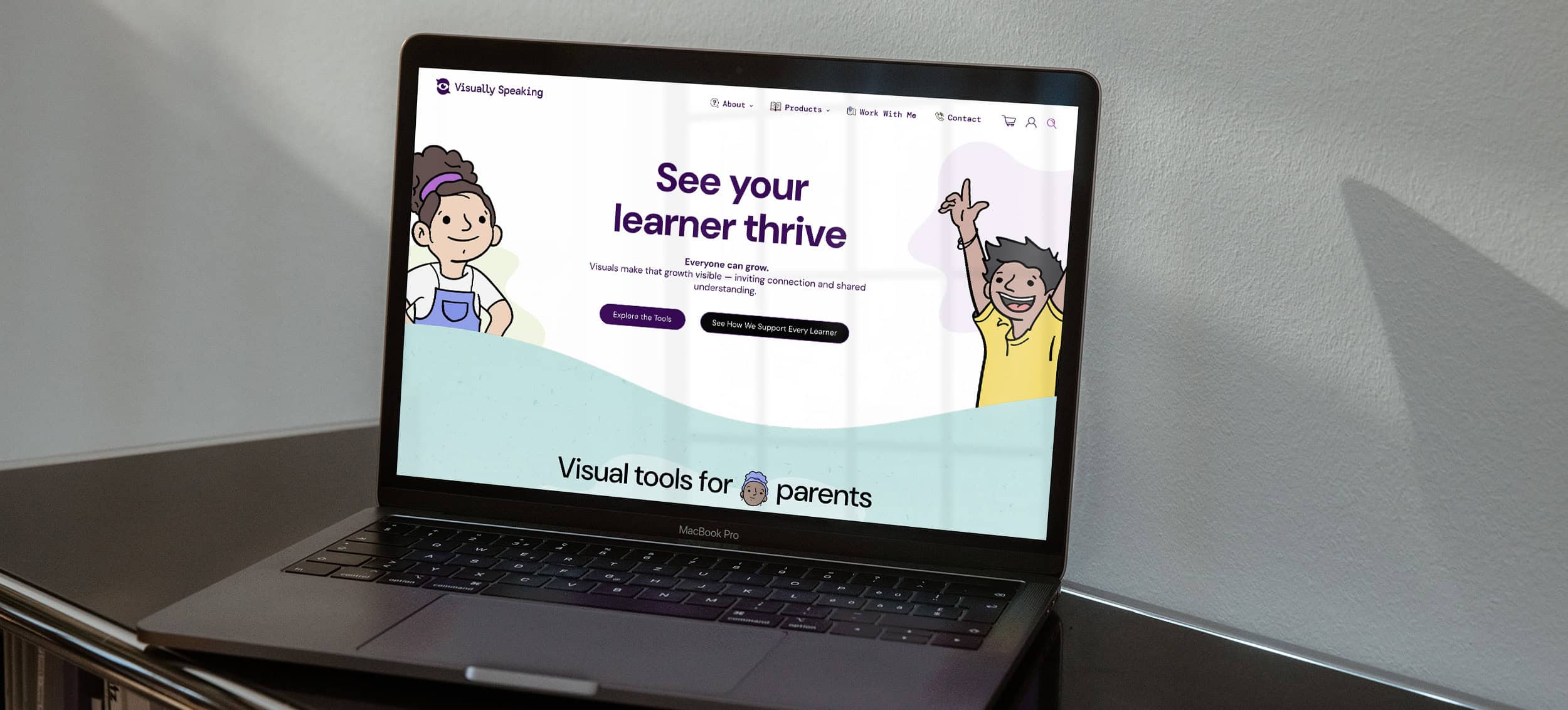 The Visually Speaking website's home page shown on a Macbook Pro sitting on a bookshelf. The home page headline reads "See your learner thrive" with illustrations of learners. 